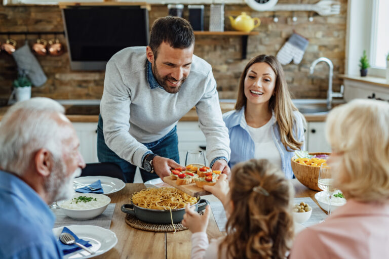 Thermomix® Help & Inspiration 9 Thermomix happy father offering bruschetta his daughter while having family lunch dining table Thermomix Limerick